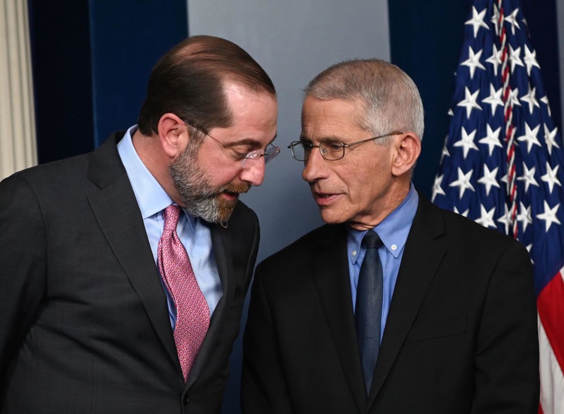 Health and Human Services Secretary Alex Azar (L) and Director of the National Institute of Allergy and Infectious Diseases at the National Institutes of Health Anthony Fauci speak before President Donald Trump arrives for a press conference on the coronavirus.