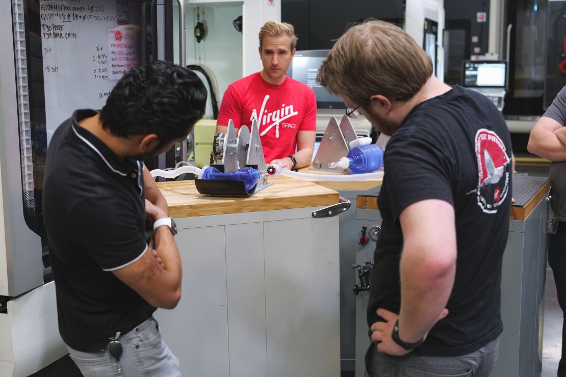 Virgin Orbit engineers (from left to right) Vishal Doshi, Victor Radulescu and Kevin Zagorski, run tests on an early prototype of a bridge ventilator. 
