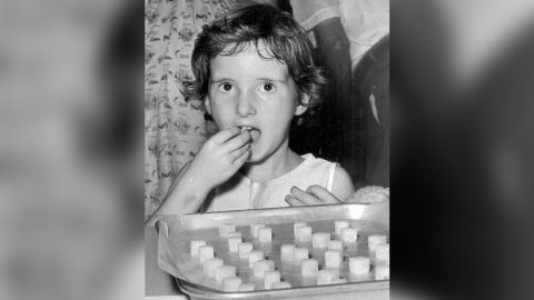 A little girl eats a sugar cube laced with the oral vaccine against polio in 1962. 