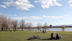 DENVER, COLORADO - APRIL 08: Many take advantage of the spring weather and open space next to the lake at Sloan's Lake Park on April 08, 2020 in Denver, Colorado. Sloan's Lake Park is home to the biggest lake in Denver and is the city's second largest park. While many of the amenities are closed due to the COVID-19 crisis, the park remains open. (Photo by Matthew Stockman/Getty Images)
