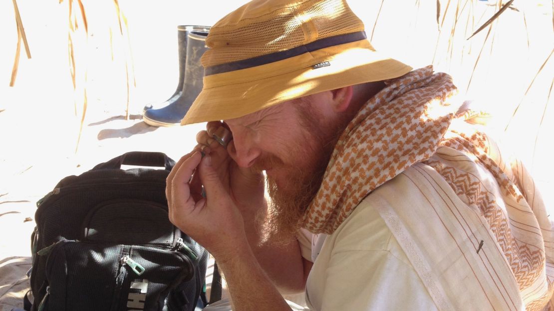 Erik Seiffert inspecting a tiny fossil at the Santa Rosa site in Amazonian Perú. [Credit: Dorien de Vries]