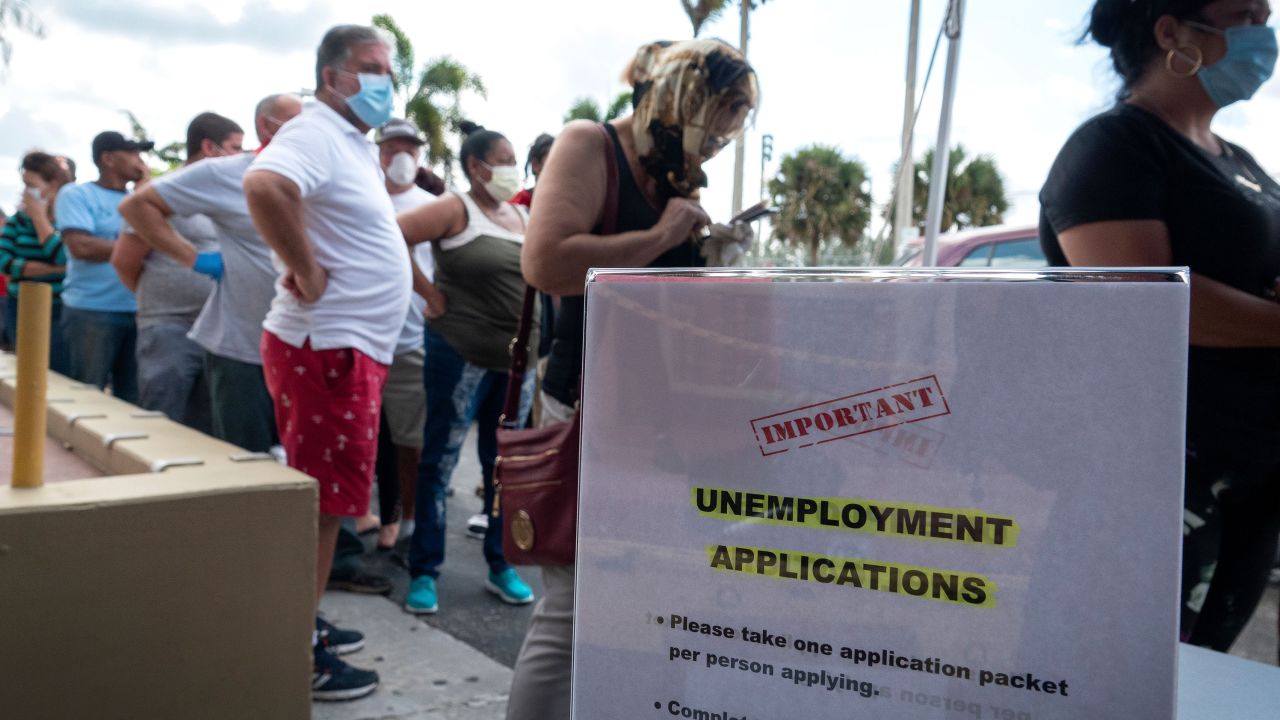 People queue to receive the printed Unemployment Benefits application in the parking lot of Kennedy Library in Hialeah, Florida, USA, 07 April 2020. Hundreds of residents lined up hours before locations were scheduled to open Tuesday across Hialeah, to submit paper applications for unemployment benefits as the state attempts to address problems with its website amid the increased number of applicants during the widespread of the SARS-CoV-2 coronavirus which causes the Covid-19 disease. (Photo by Cristibal Herrera/EPA-EFE/Shutte/Shutterstock)