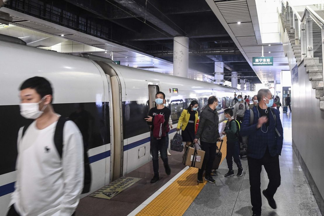 Passengers alight from the first train out of Wuhan in Nanning city, in China's Guangxi region, on Wednesday.