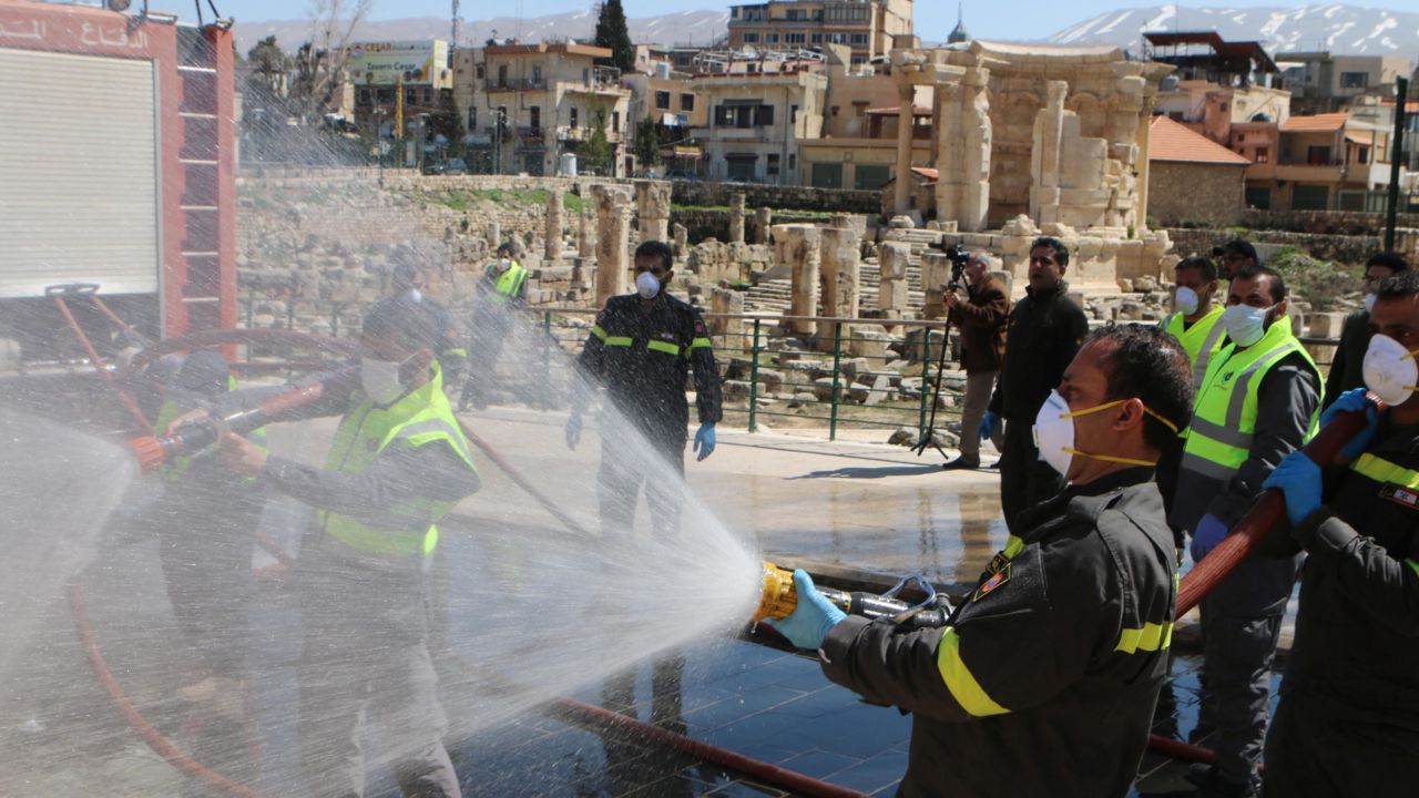 Members of the Lebanese civil defense forces spray disinfectant at Baalbek's Roman ruins on March 16.
