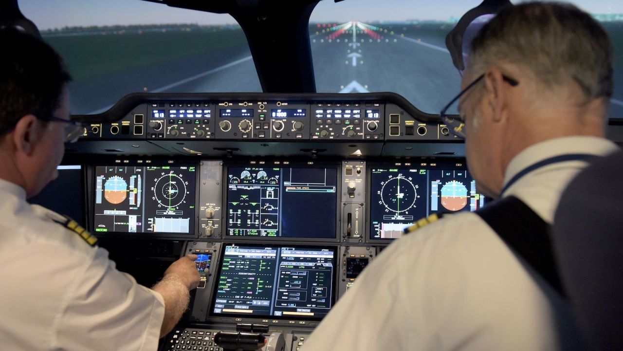 Air France pilots sit inside an Airbus A350 flight simulator at the company training centre near Roissy Charles de Gaulle airport.