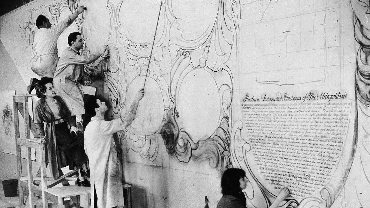 American artist Allen Saalburg directs WPA artists at work in a temporary studio at the American Museum of Natural History on murals commissioned for the Arsenal Building in Central Park, New York (1935)