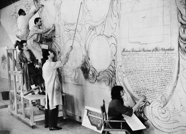 American artist Allen Saalburg directs WPA artists at work in a temporary studio at the American Museum of Natural History on murals commissioned for the Arsenal Building in Central Park, New York (1935) 