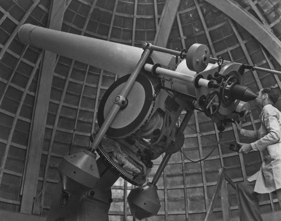 Technician Carter Baughman at the sights of the new twelve-inch Zeiss refracting telescope at Griffith Observatory, Los Angeles (1935)