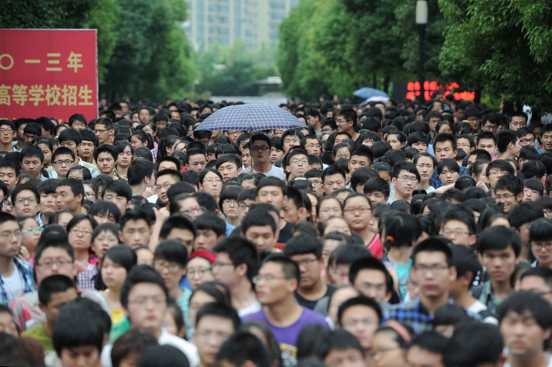 Students walk out from a schoolyard after finishing the first subject of the 2013 university entrance exam in Hefei, north China's Anhui province.