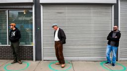 DENVER, CO - MARCH 23: People stand in freshly painted circles, six-feet-apart, as they wait in a two-hour line to buy marijuana products from Good Chemistry on March 23, 2020 in Denver, Colorado. Residents stock up on essentials before stores close for three weeks amid a shelter-in-place order starting Tuesday evening due to the coronavirus (COVID-19) outbreak. Denver Mayor Michael Hancock announced liquor stores and marijuana dispensaries would be allowed to stay open as long as they enforced extreme social distancing practices. (Photo by Michael Ciaglo/Getty Images)