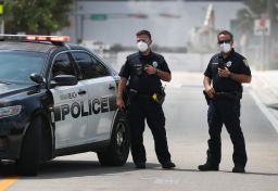 Miami Beach police officers wear protective masks.