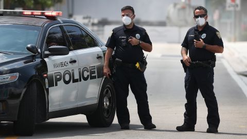 Miami Beach police officers wear protective masks.