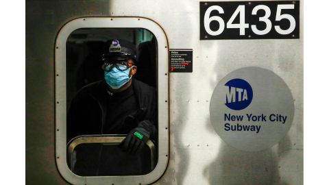 An MTA worker wears a surgical mask at the Grand Army Plaza station in Brooklyn. 