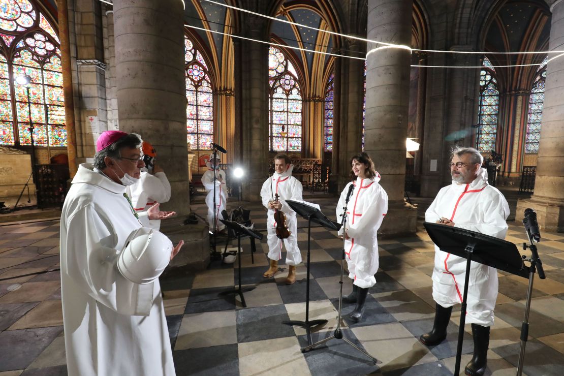 From left to right, Archbishop of Paris Michel Aupetit speaks with violonist Renaud Capucon, actor Judith Chemla and actor Philippe Torreton as during a meditation ceremony to celebrate Good Friday.