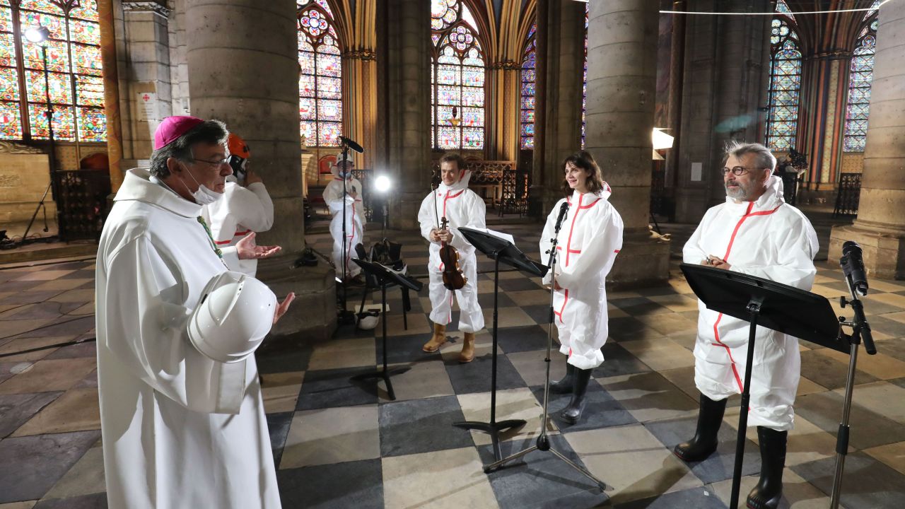 From left to right, Archbishop of Paris Michel Aupetit speaks with violonist Renaud Capucon, actor Judith Chemla and actor Philippe Torreton as during a meditation ceremony to celebrate Good Friday.