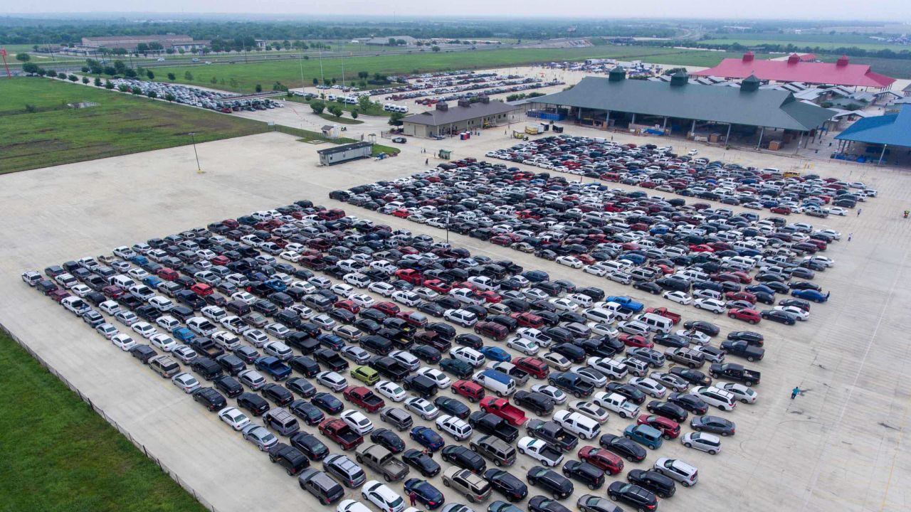 People wait in their cars Thursday, April 9, 2020, at Traders Village for the San Antonio Food Bank to begin food distribution. The need for emergency food aid has exploded in recent weeks due to the COVID-19 pandemic. The Labor Department said Thursday 6.6 million people applied for first-time unemployment benefits. (William Luther/The San Antonio Express-News via AP)
