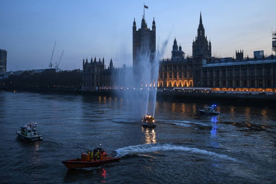 Service boats spray water in London to show support for health care workers on April 9, 2020.