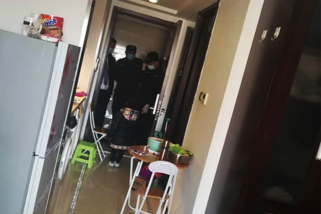 Police come to the house of an African resident in Beijing.