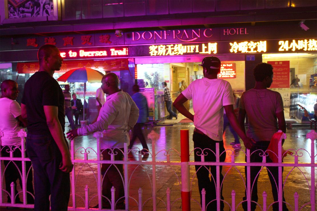 Africans stand in front of the Don Franc hotel in Guangzhou, before the coronavirus crisis.