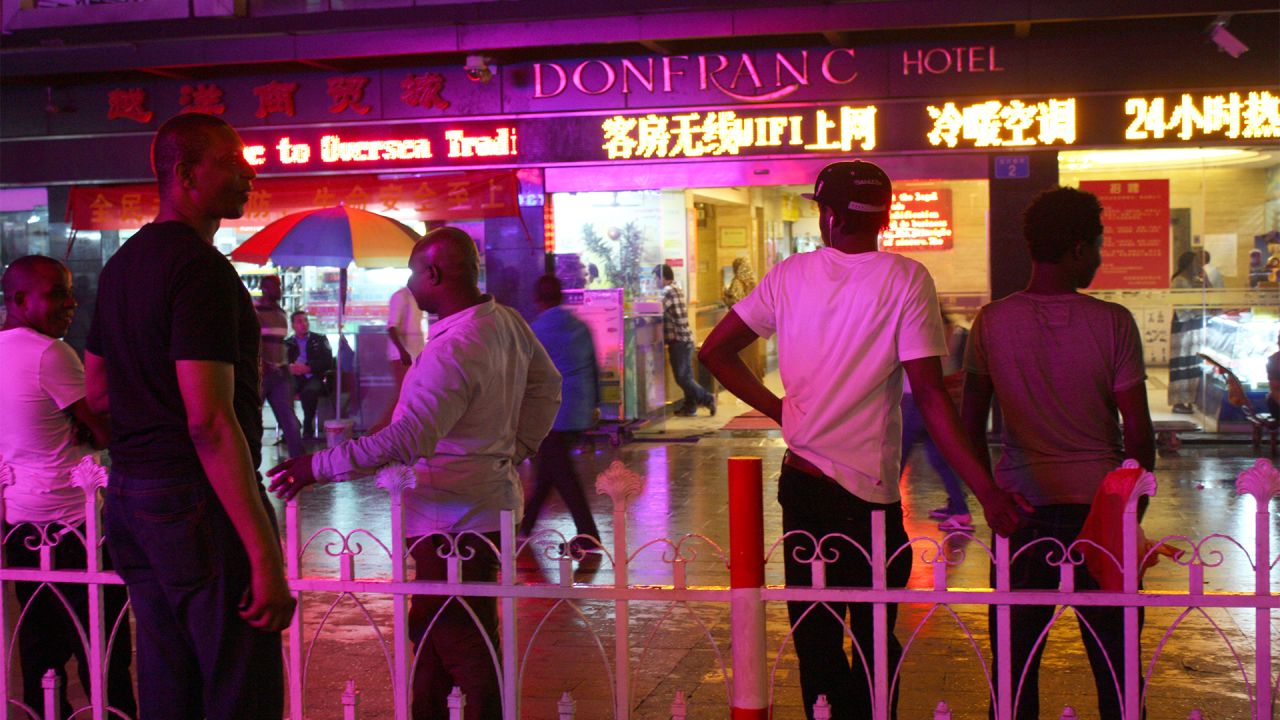 Africans stand in front of the Don Franc hotel in Guangzhou, before the coronavirus crisis.