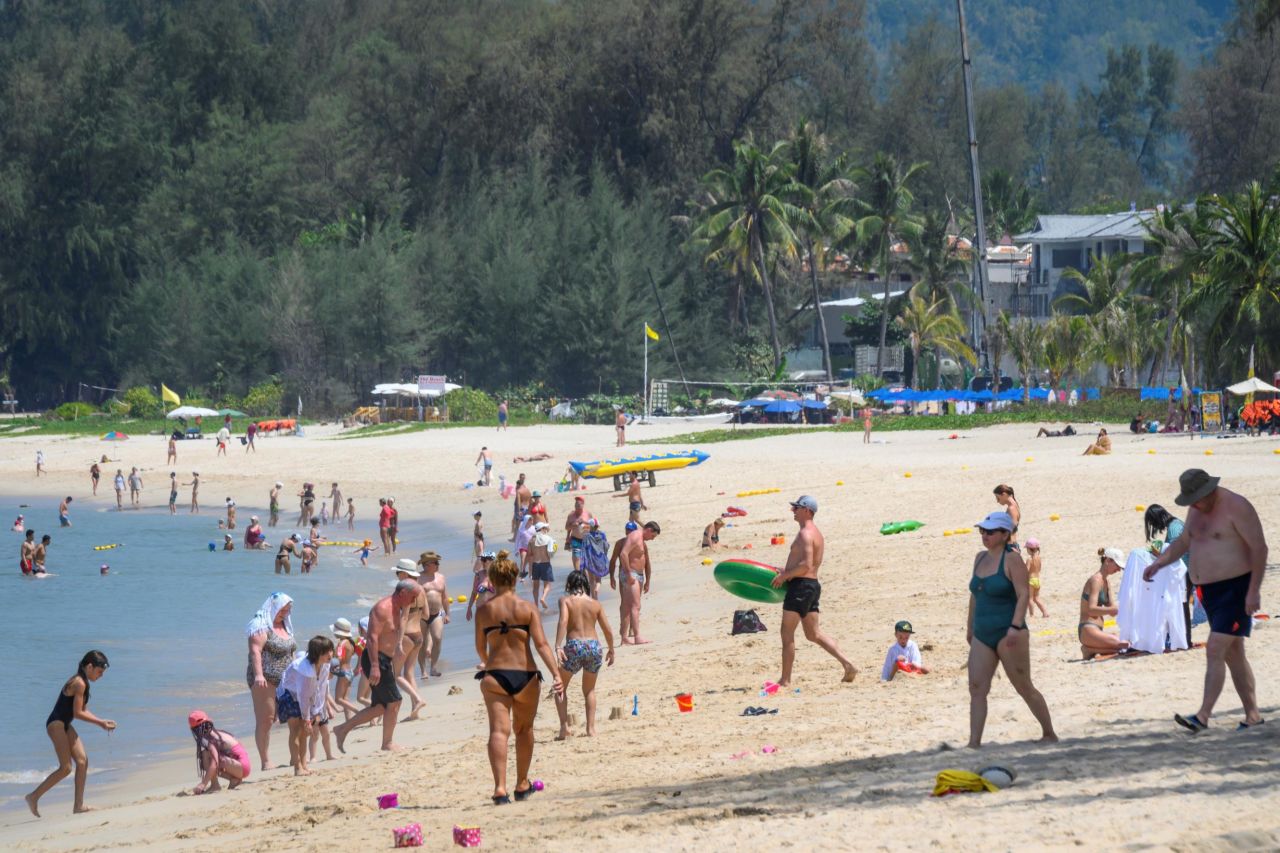 This photo, taken on March 20, 2020, shows tourists enjoying one of Phuket's many beaches. On March 28, all of the island's beaches were closed. 