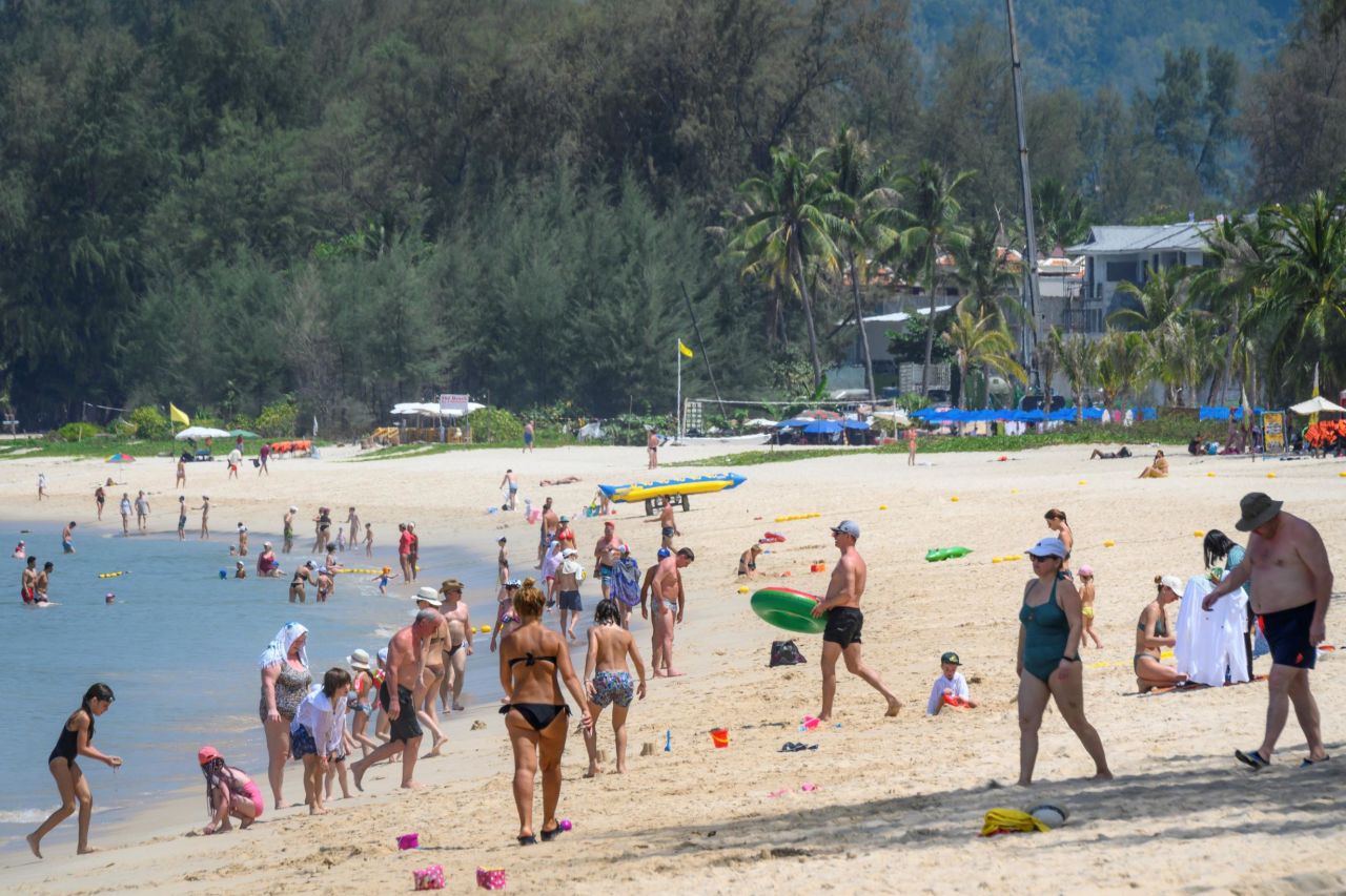This photo, taken on March 20, 2020, shows tourists enjoying one of Phuket's many beaches. On March 28, all of the island's beaches were closed.