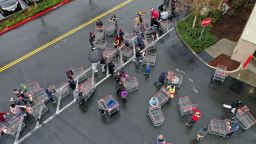 Hundreds of people line up to enter a Costco store on March 14, 2020 in Novato, California. Some Americans are stocking up on food, toilet paper, water and other items after the World Health Organization (WHO) declared Coronavirus (COVID-19) a pandemic. (Photo by Justin Sullivan/Getty Images)