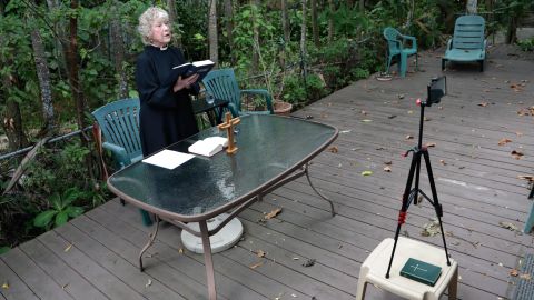 Rev. Jo-Ann Murphy, assistant rector of St. Stephen's Episcopal Church, livestreams a Good Friday Mass from her backyard during the coronavirus pandemic.