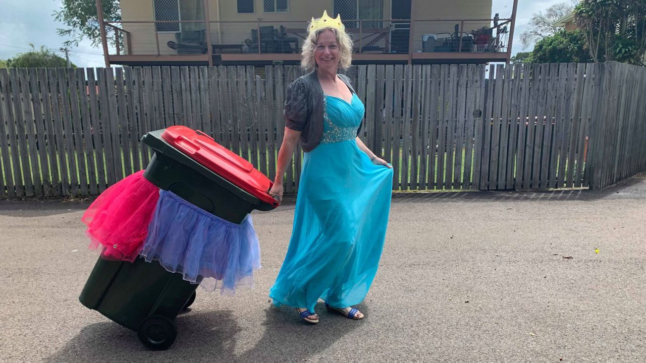 Danielle Askew, who created the Facebook group Bin Isolation Outing, is pictured here taking her trash out all dressed up.