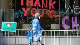 NEW YORK, NY - APRIL 9: A Montefiore Medical Center employee walks past signs thanking the medical staff on April 9, 2020 in New York City. New York Governor Andrew Cuomo said that while signs show that measures taken by New Yorkers are beginning to flatten the curve, COVID-19 deaths across the state hit a daily record for the third straight day on Wednesday with 799 fatalities.  (Photo by David Dee Delgado/Getty Images)