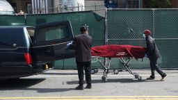 Funeral parlor workers move a body from a refrigeration truck serving as a temporary morgue at the Brooklyn Hospital Center to a hearse, in the Borough of Brooklyn on April 8, 2020 in New York. - New York recorded a new single-day high for coronavirus deaths on April 8, but Governor Andrew Cuomo said the epidemic appeared to be stabilizing. Cuomo said 779 people had died in the last 24 hours, bringing the total death toll in New York state from COVID-19 to 6,268. (Photo by Bryan R. Smith / AFP) (Photo by BRYAN R. SMITH/AFP via Getty Images)