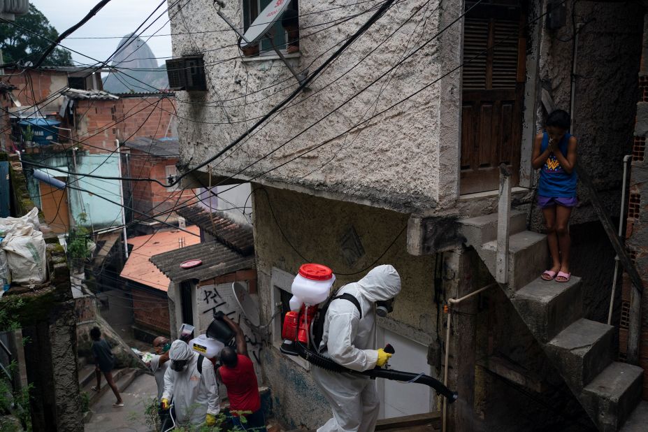 Volunteers spray disinfectant in a favela in Rio de Janeiro.