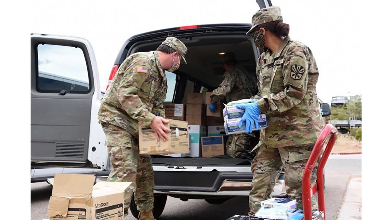 Arizona National Guard soldiers load PPE into a van destined for Shiprock, New Mexico, on Navajo Nation land.