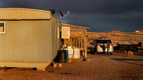 A Navajo woman carries wood to heat her rural mobile home during the coronavirus pandemic on March 27, 2020, in Cameron, Arizona. 