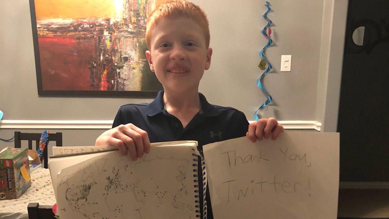 Brandon and his map after Twitter users from all over the world responded with their locations.