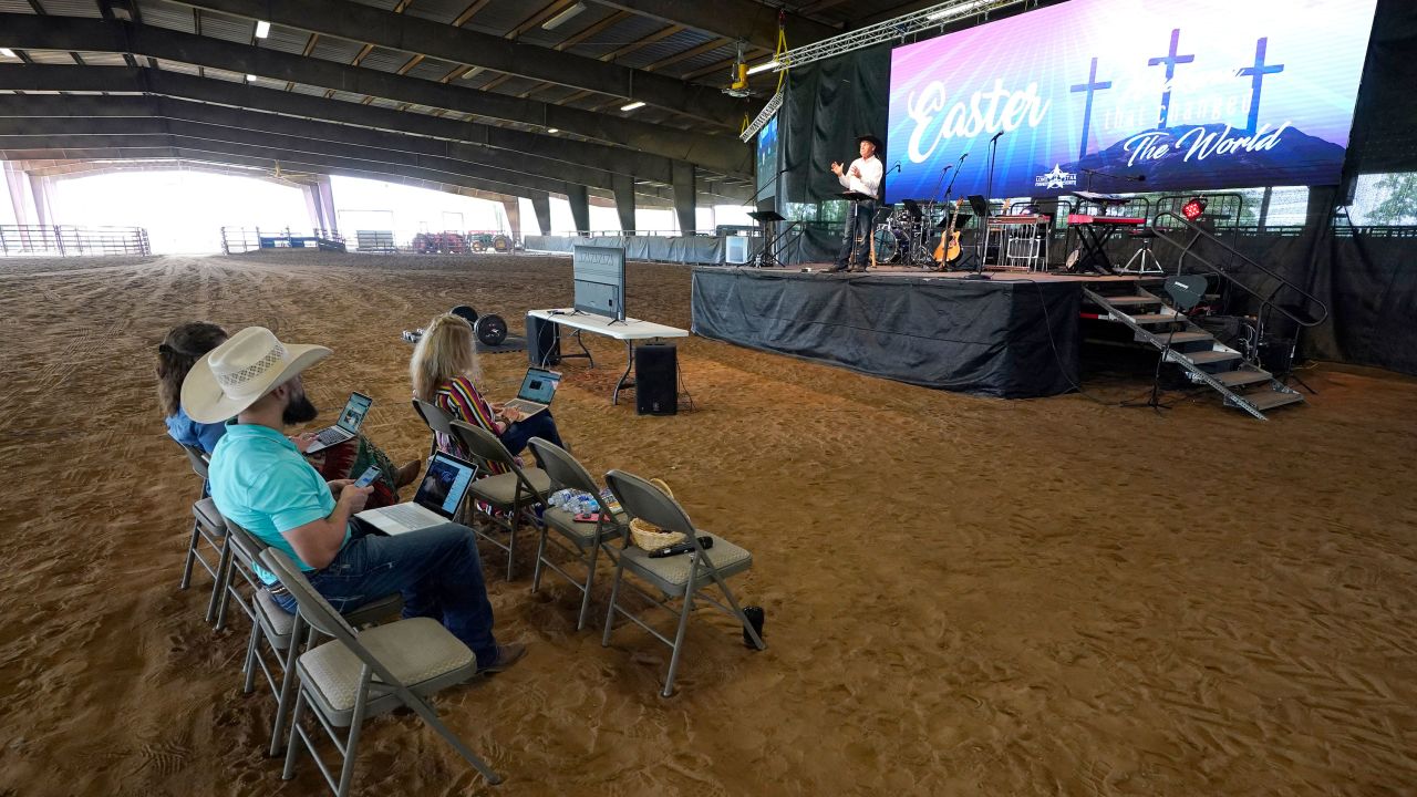 Lone Star Cowboy Church Pastor Randy Weaver, right, conducts a livestreamed service in Montgomery, Texas.