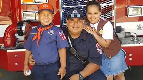 Late firefighter Israel Tolentino Jr. (center), and his two children. Tolentino Jr., of Passaic, New Jersey, died from complications due to the novel coronavirus, his wife said.