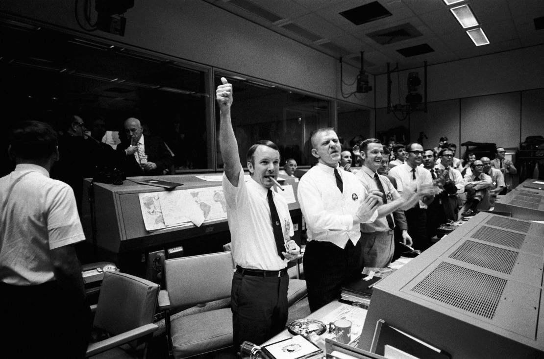Mission Control erupts into cheers and applause as the Apollo 13 astronauts return to Earth.