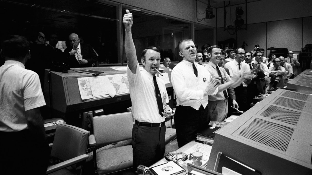 Mission Control erupts into cheers and applause as the Apollo 13 astronauts return to Earth.