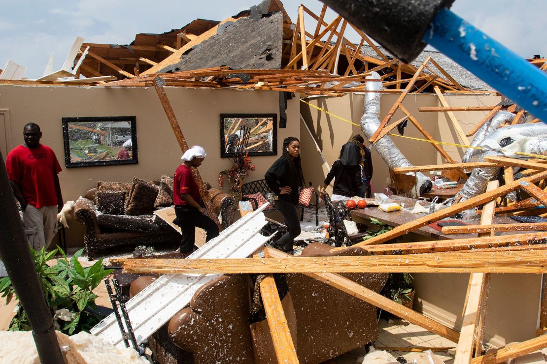 Residents look at the remains of their home after a tornado ripped through Monroe, Louisiana, on Easter Sunday.

