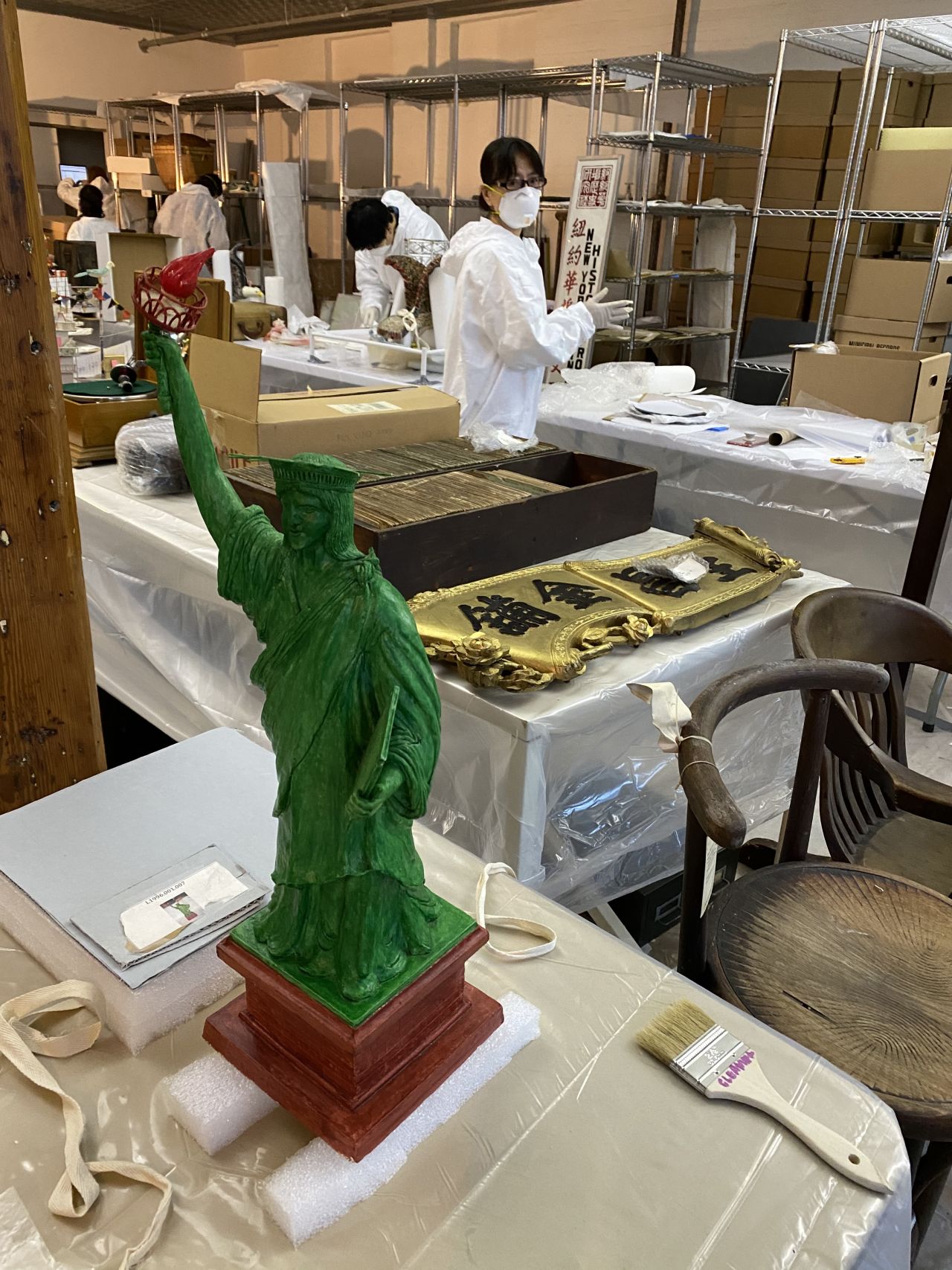 A paper sculpture of the Statue of Liberty from MOCA's "Fly to Freedom" collection of paper art made by undocumented immigrants from China while in detention in the U.S., and other rescued items from MOCA's archives being restored in February 2020.