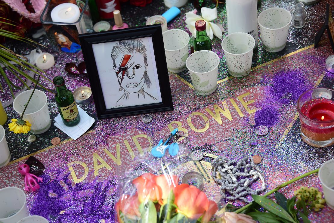 Flowers and other momentos are left at the Hollywood Star of David Bowie in Hollywood (2016).