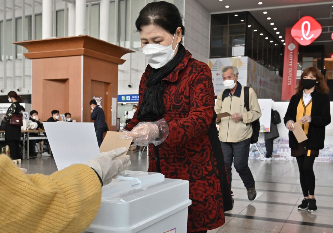 A South Korean woman casts a ballot during early voting at a polling station in Seoul on April 10.