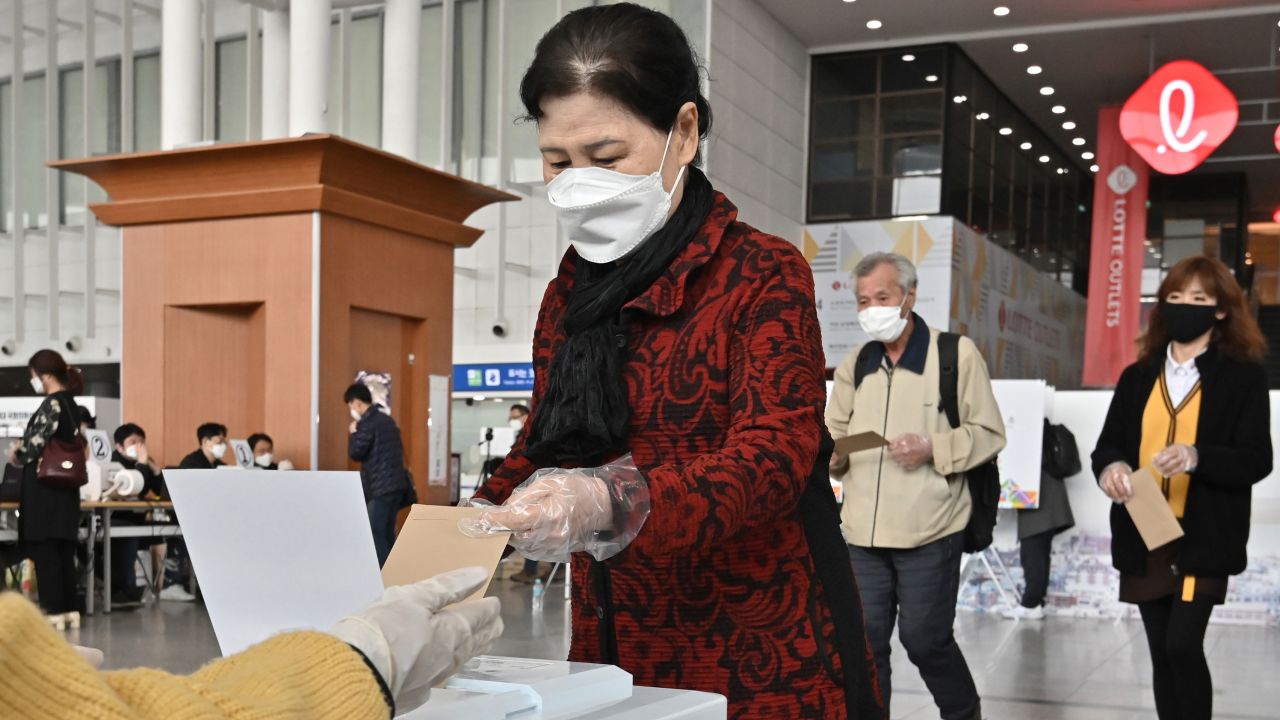 A South Korean woman casts a ballot during early voting at a polling station in Seoul on April 10.