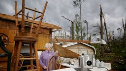 Emma Pritchett, 78, hold up a broken glass from her kitchen sink the day after a tornado hit on Monday, April 13, 2020, in Chatsworth, Ga.