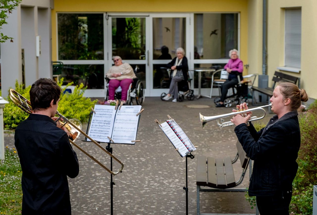 Musicians play their instruments for a retirement home in Karben, Germany.