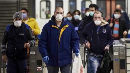 MADRID, SPAIN - APRIL 13: Spanish workers wear masks leaving the subway on April 13, 2020 in Madrid, Spain.  More than 15,000 people are reported to have died in Spain due to the COVID-19 outbreak, although the country has reported a decline in the daily number of deaths. (Photo by Borja B. Hojas/Getty Images)