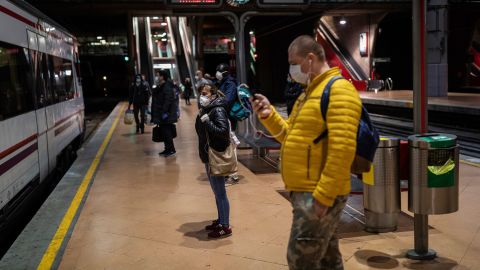 Commuters wearing face masks to protect against coronavirus at the platform of Atocha train station in Madrid, Spain, on Monday.