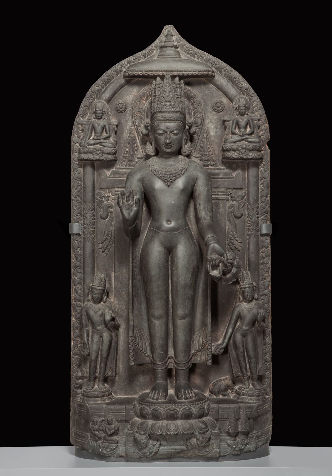 A basalt statue: "Standing crowned Buddha with four scenes of his life," approx. 1050--1100. southern Magadha region, Bihar state, India. Part of the Brundage Collection at the Asian Art Museum, San Francisco.