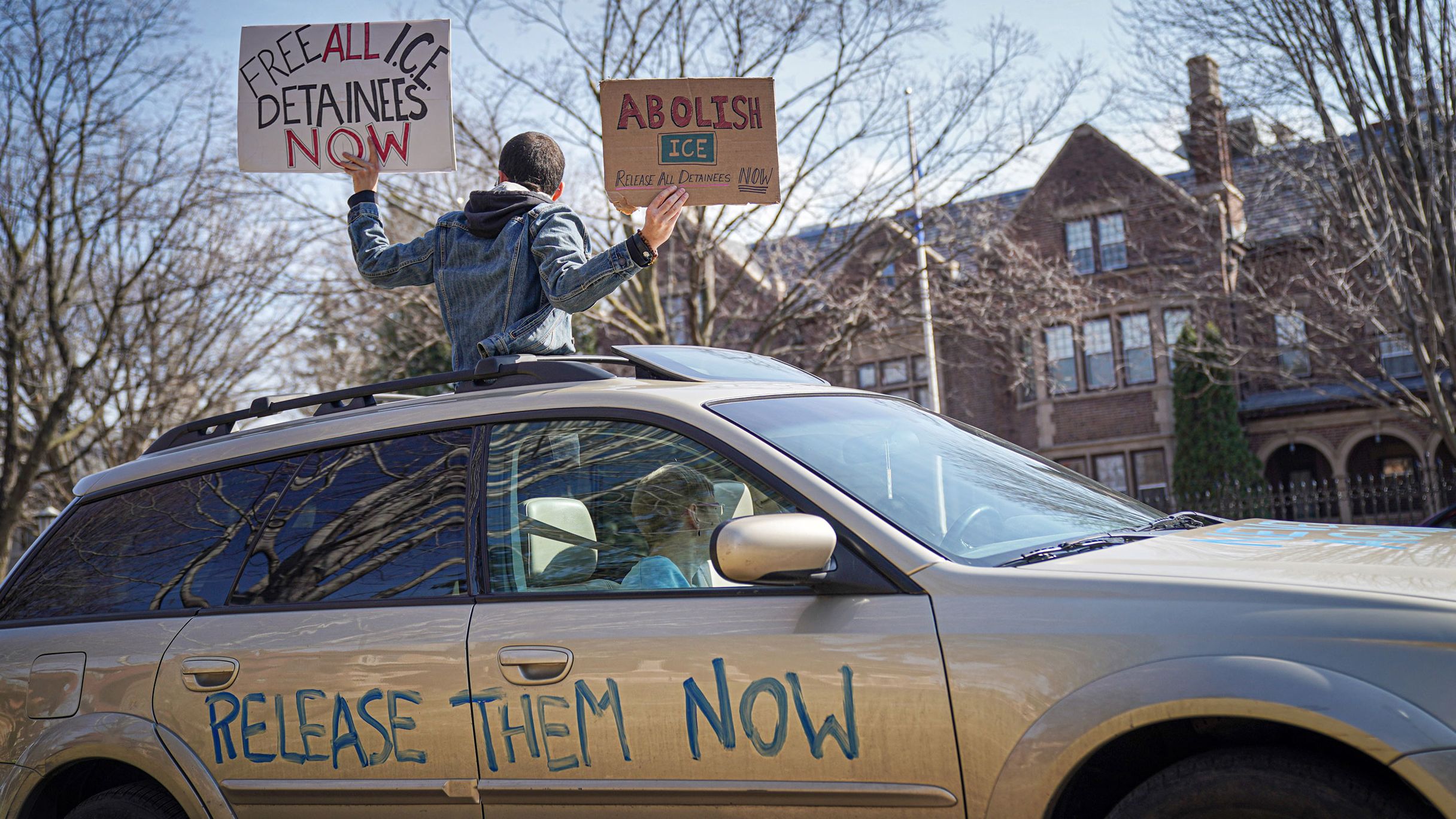 Activists who stayed mostly in their cars for social distancing honked horns outside the Governor's Residence in St. Paul, Minnesota, on March 27.